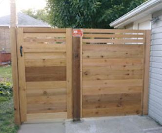 A wooden gate next to a house