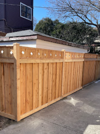 A wooden fence is sitting on the sidewalk next to a house
