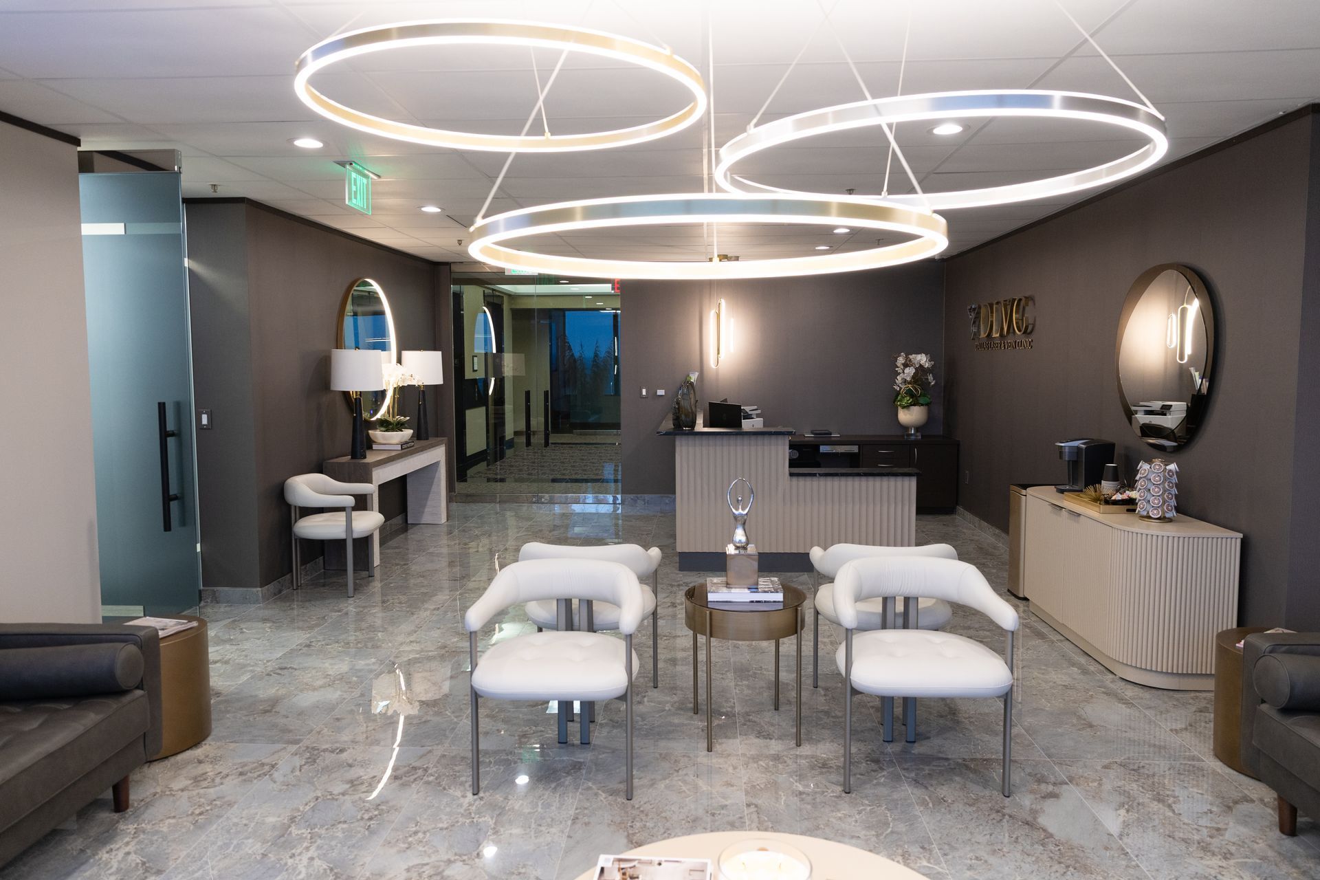 Elegant waiting room with chairs, a reception desk, and circular lights.