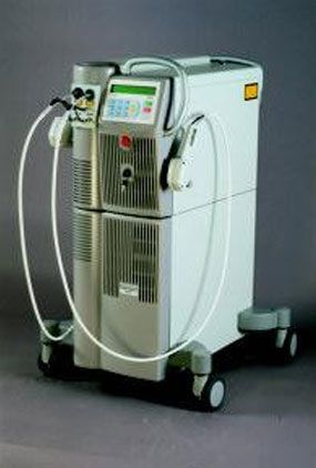 White medical laser machine on wheels with control panel and cables, shown against a gray background