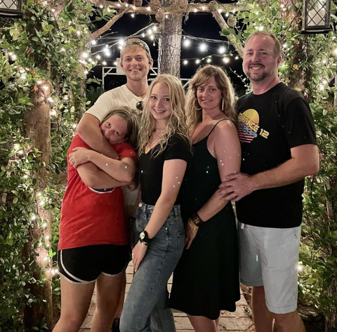 A group of people are posing for a picture in front of a gazebo.