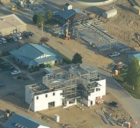 an aerial view of a building under construction in a residential area