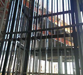 the inside of a building under construction with a lot of metal frames .