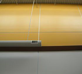 a ceiling fan is hanging from the ceiling of a building .