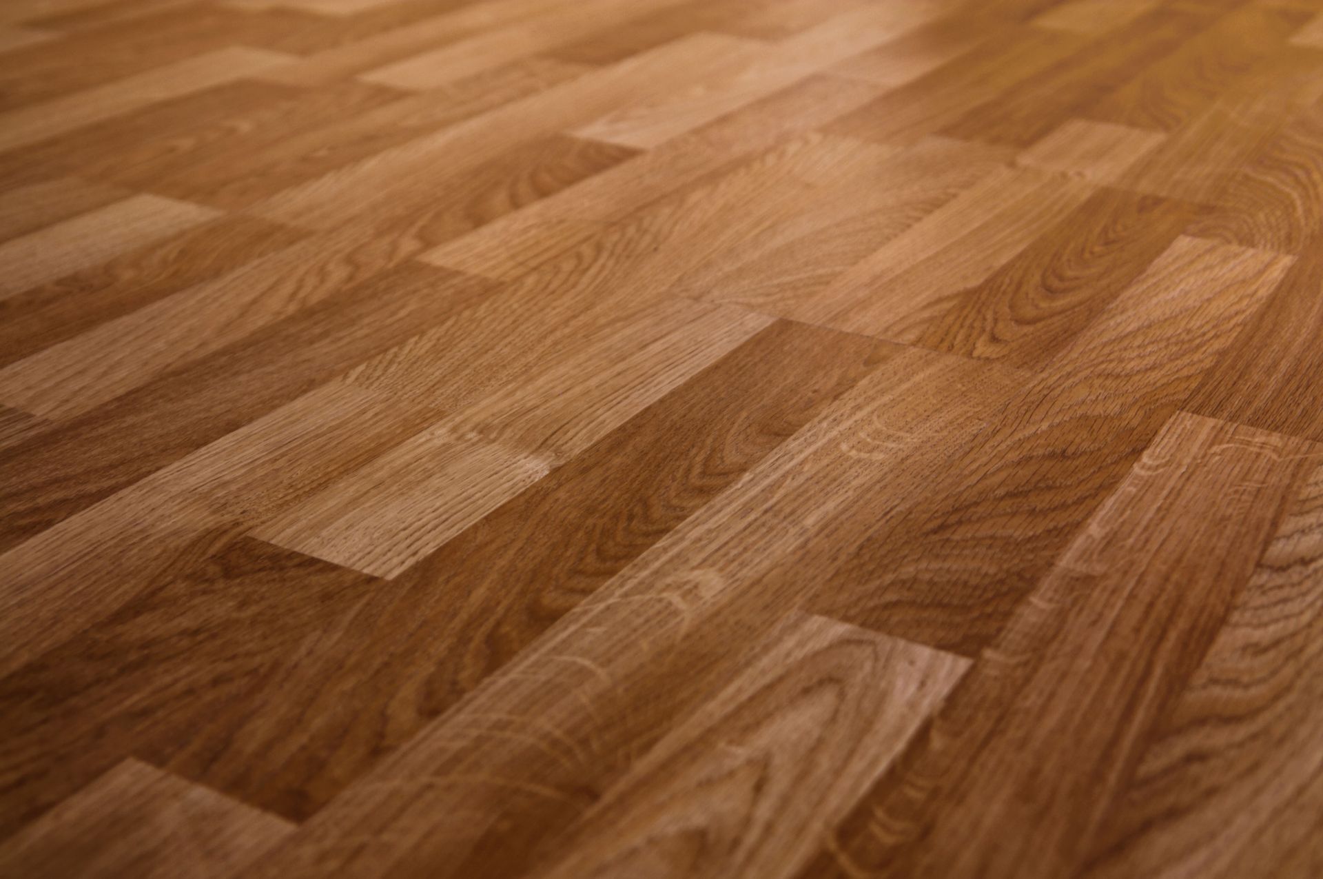 A close up of a wooden floor with a diagonal pattern.