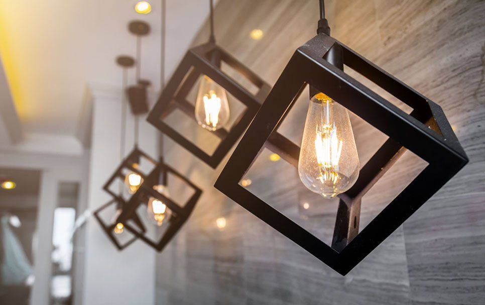 A group of pendant lights hanging from the ceiling in a room.