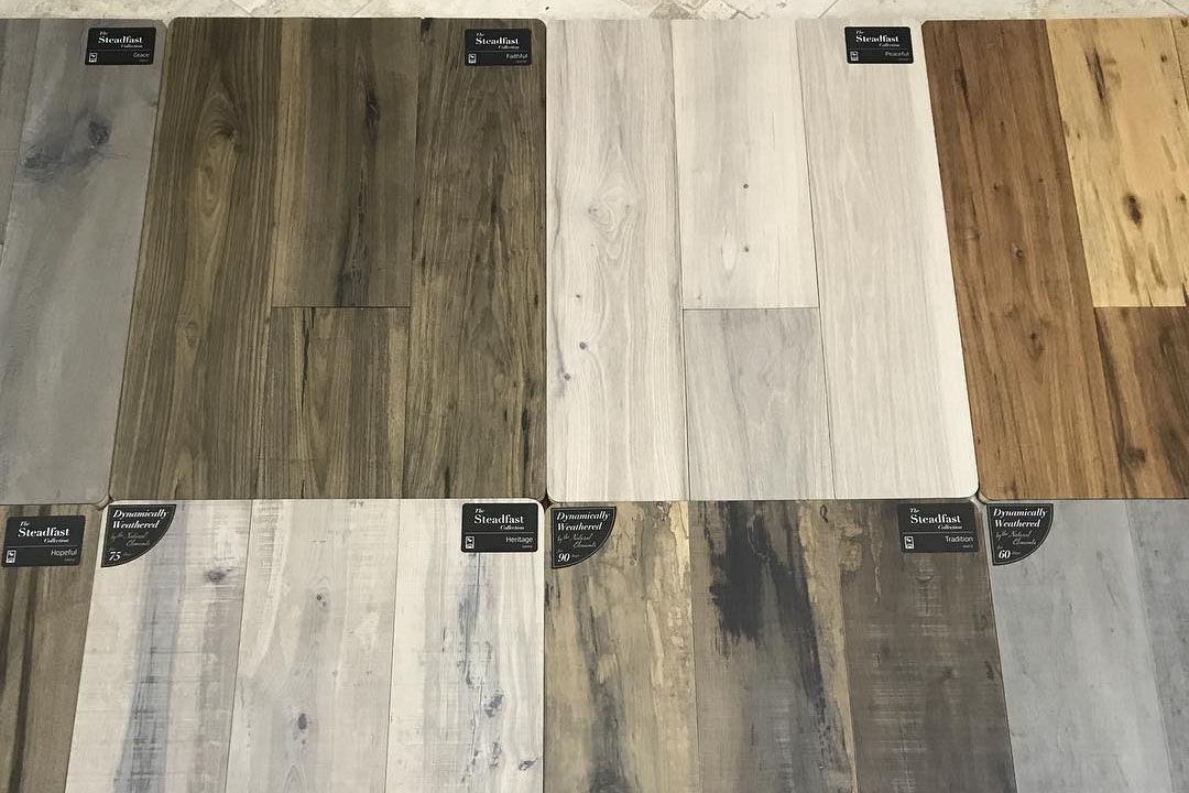 A variety of different types of wood flooring are displayed on a table.