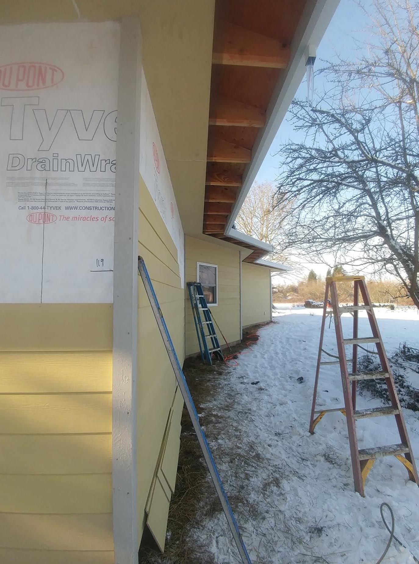 A bathroom with tiled walls and a walk-in shower.