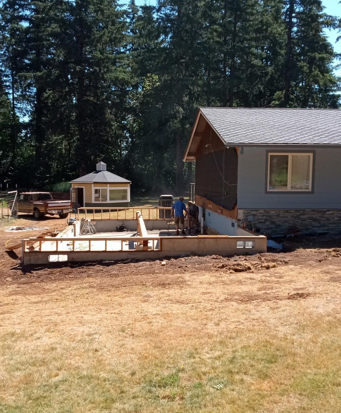 A house is being built in the middle of a field