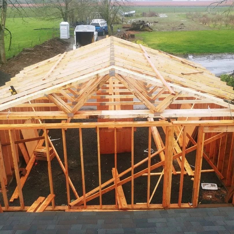 A wooden structure with a roof being built