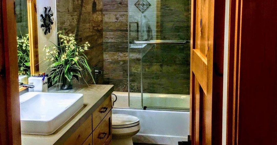 A bathroom with a sink, toilet, tub and shower