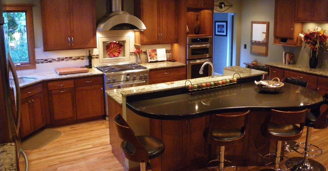 A kitchen with a large island and stools