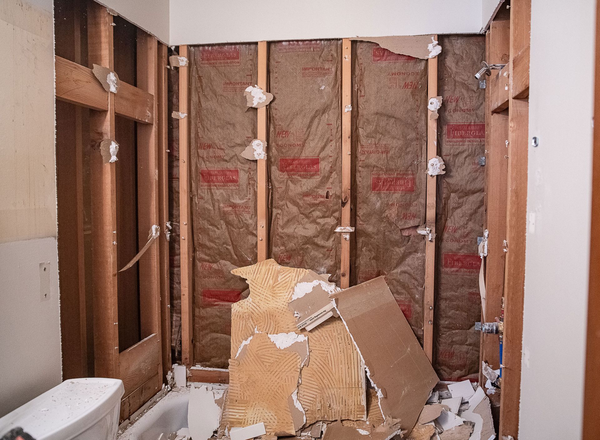A bathroom under construction with a toilet and a bathtub