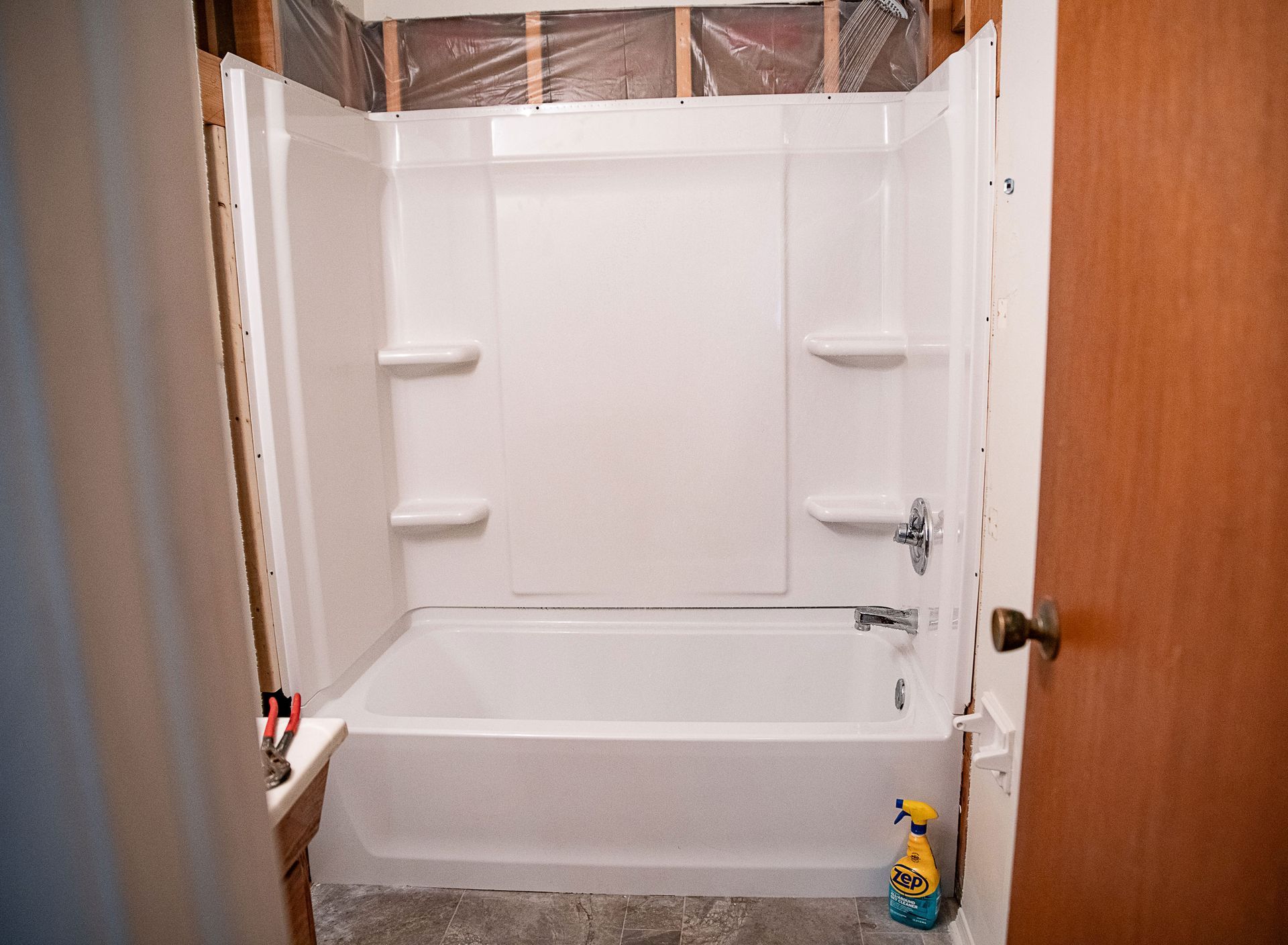 A bathroom with a bathtub and shower stall