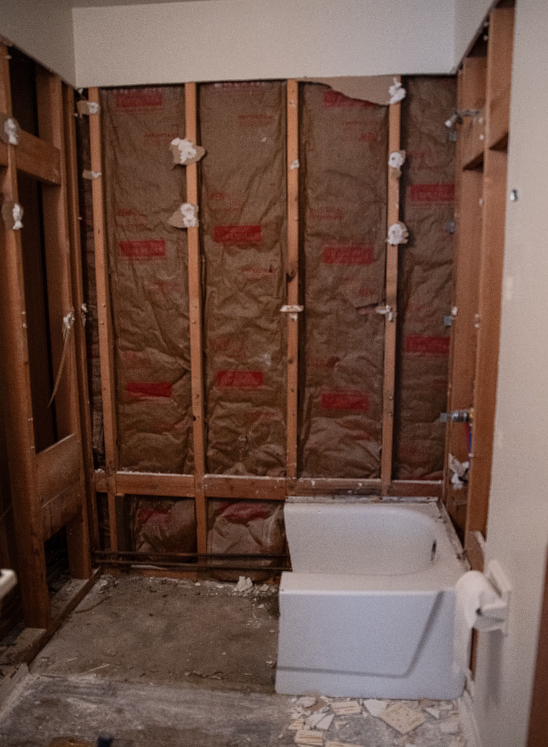 A bathtub is sitting in a bathroom under construction