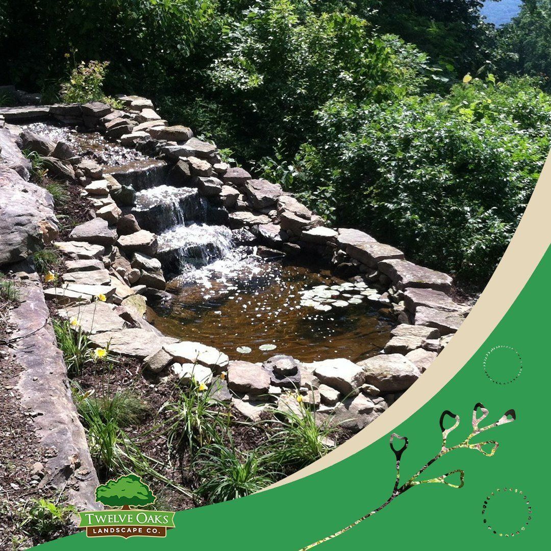 Waterfall feature with stone construction in a garden setting.
