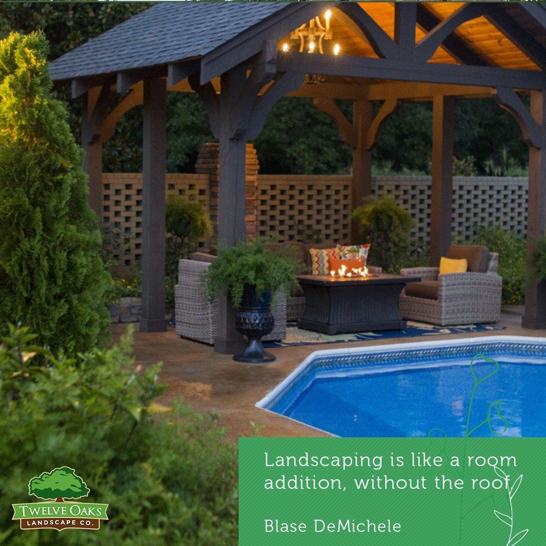A backyard patio with a pool, gazebo, furniture, and landscaping, lit by overhead lights and a fire pit.