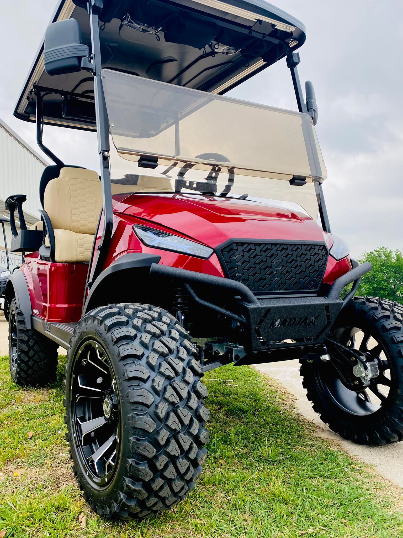 A close up of a white leather seat with blue stitching