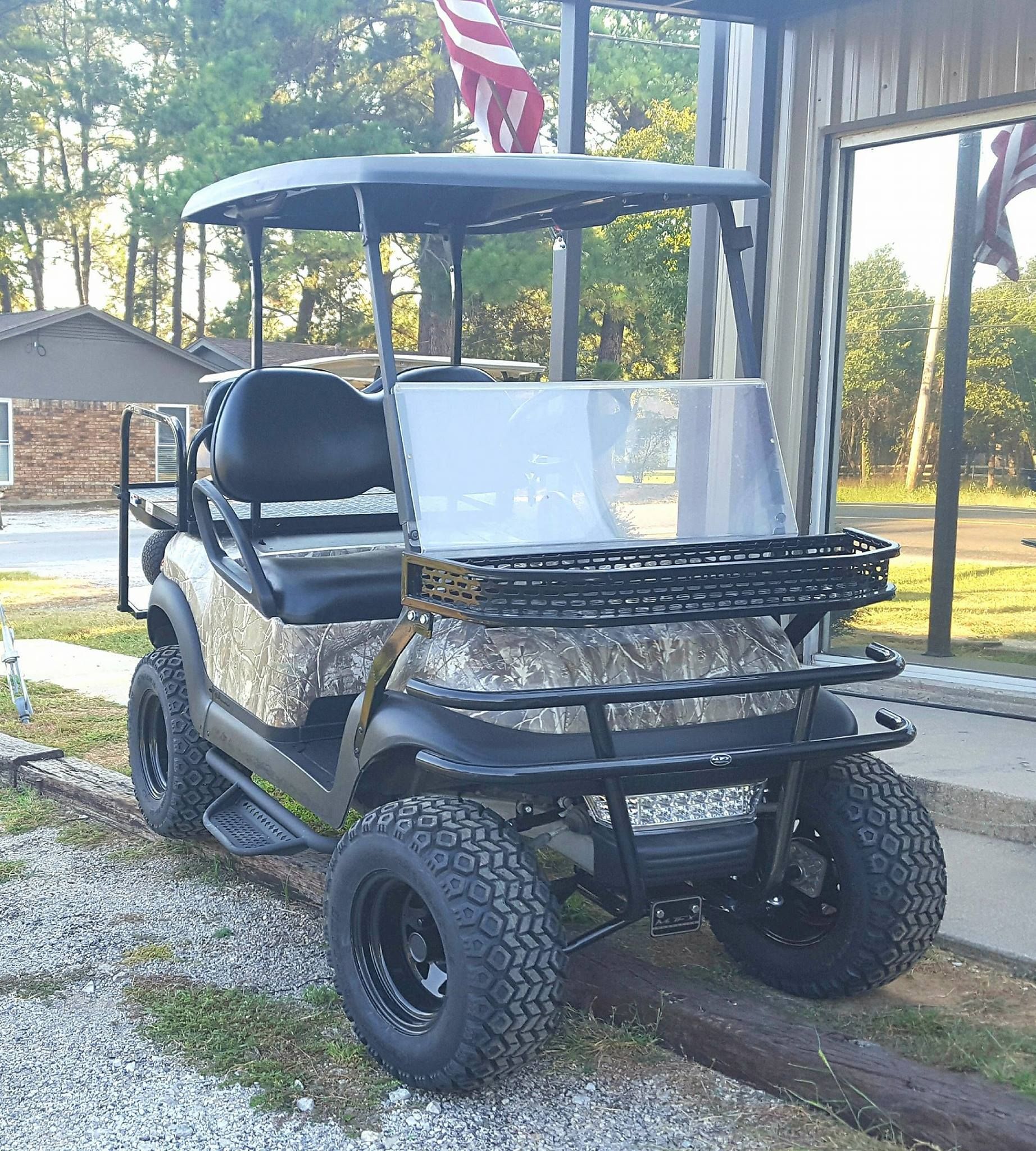 A golf cart is parked in front of a building.