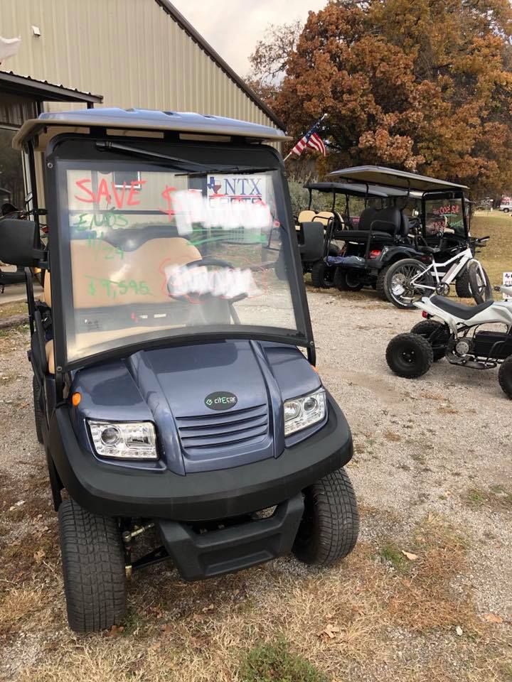 A golf cart is parked in front of a building.