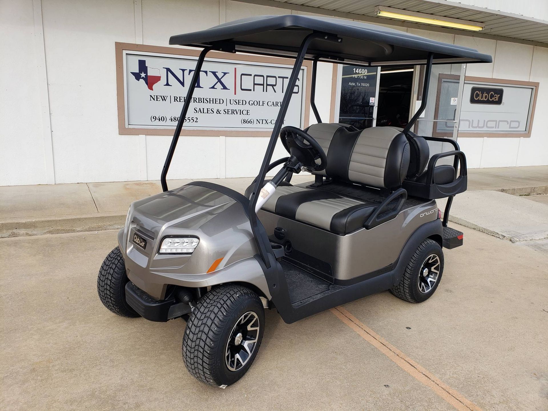 A golf cart is parked in front of a building.