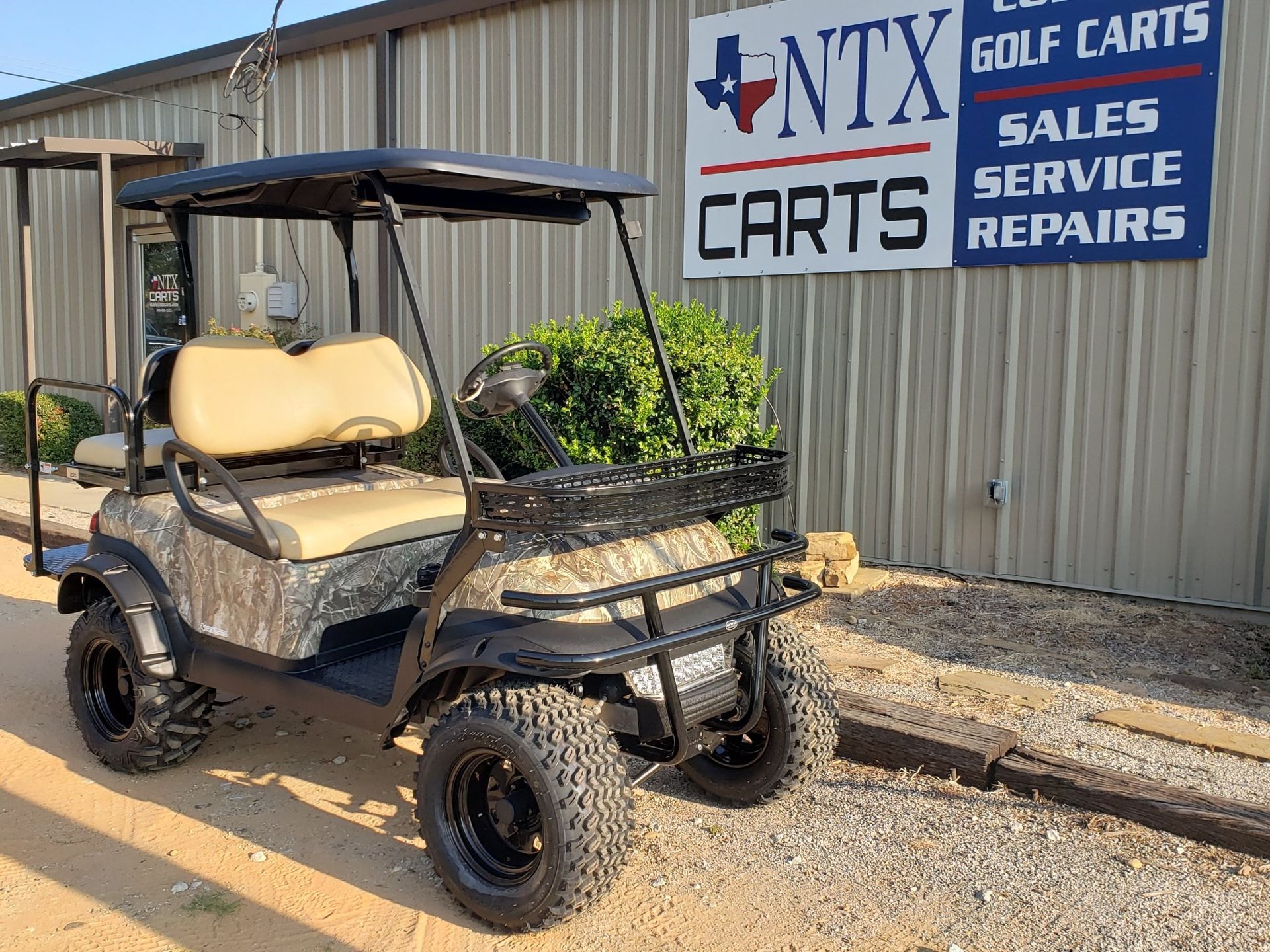 A golf cart is parked in front of a building.