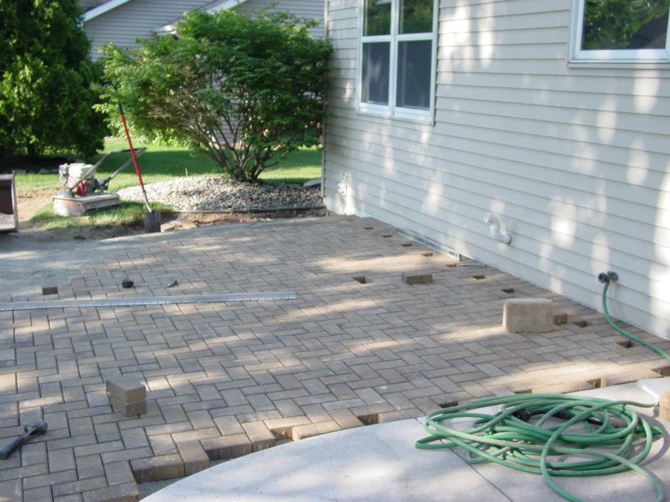 Cutting in the new brick patio.