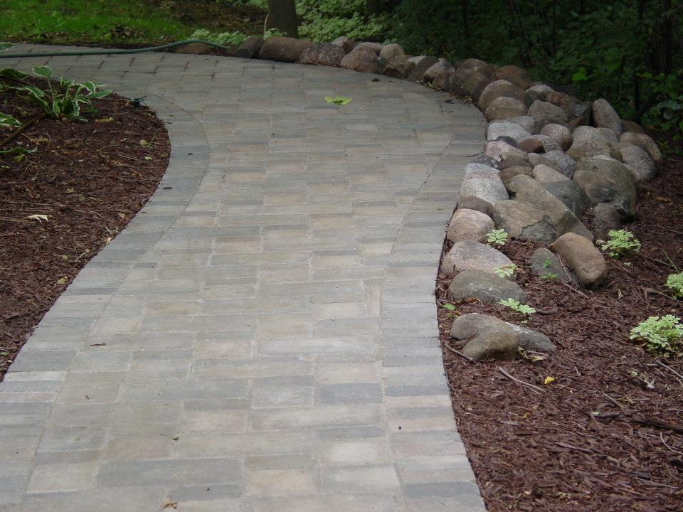 The back corner of the house. We used existing cobblestone from the site to rip rap the bank where it slopes to the woods.