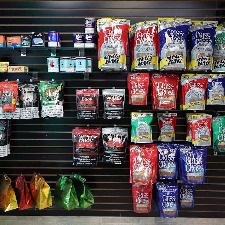 Shelves displaying tobacco products in various colorful packages.