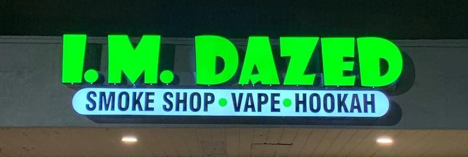 Green neon sign: I.M. DAZED, smoke shop, vape, hookah.
