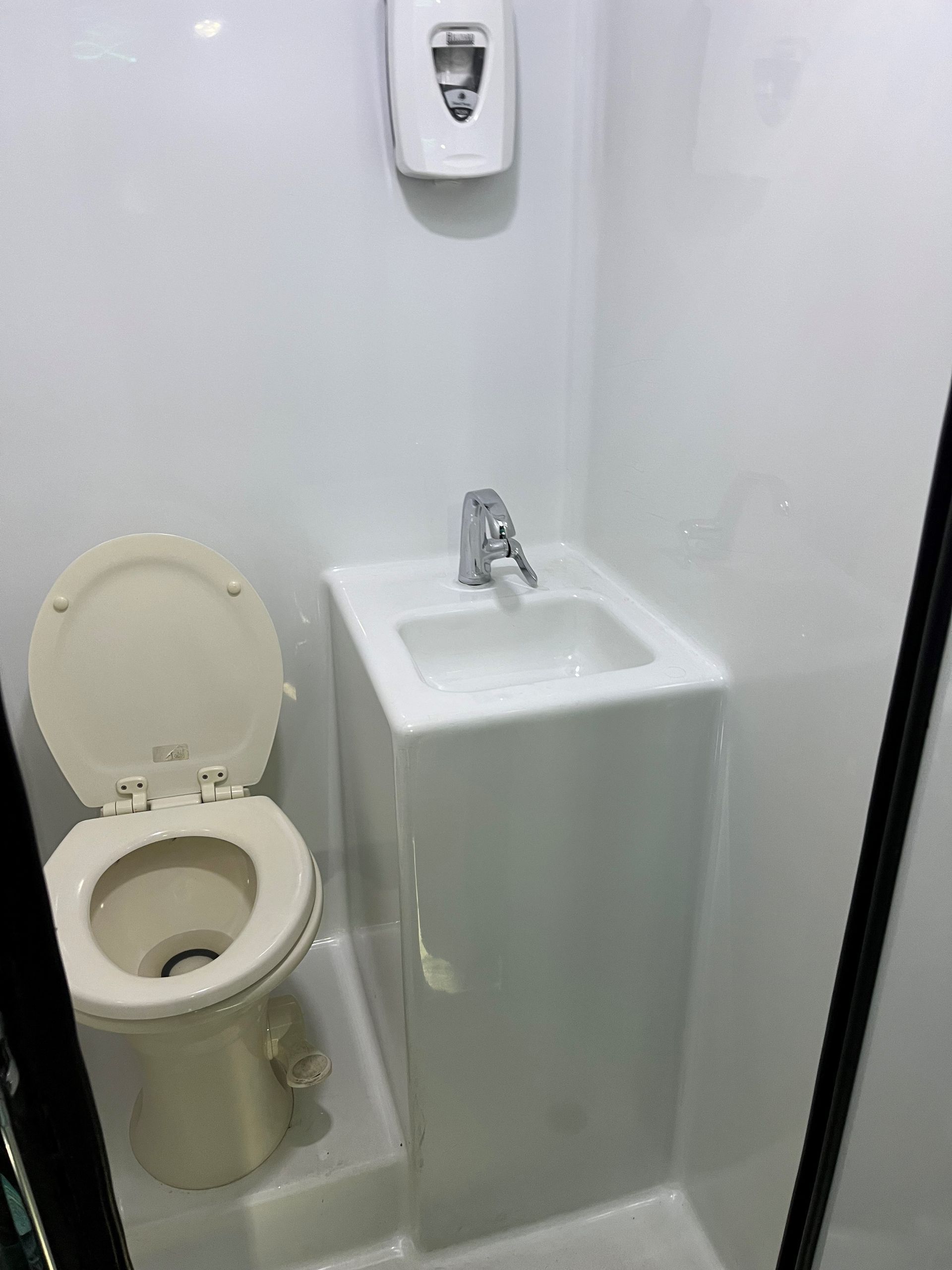 A bathroom with a toilet and a sink in it