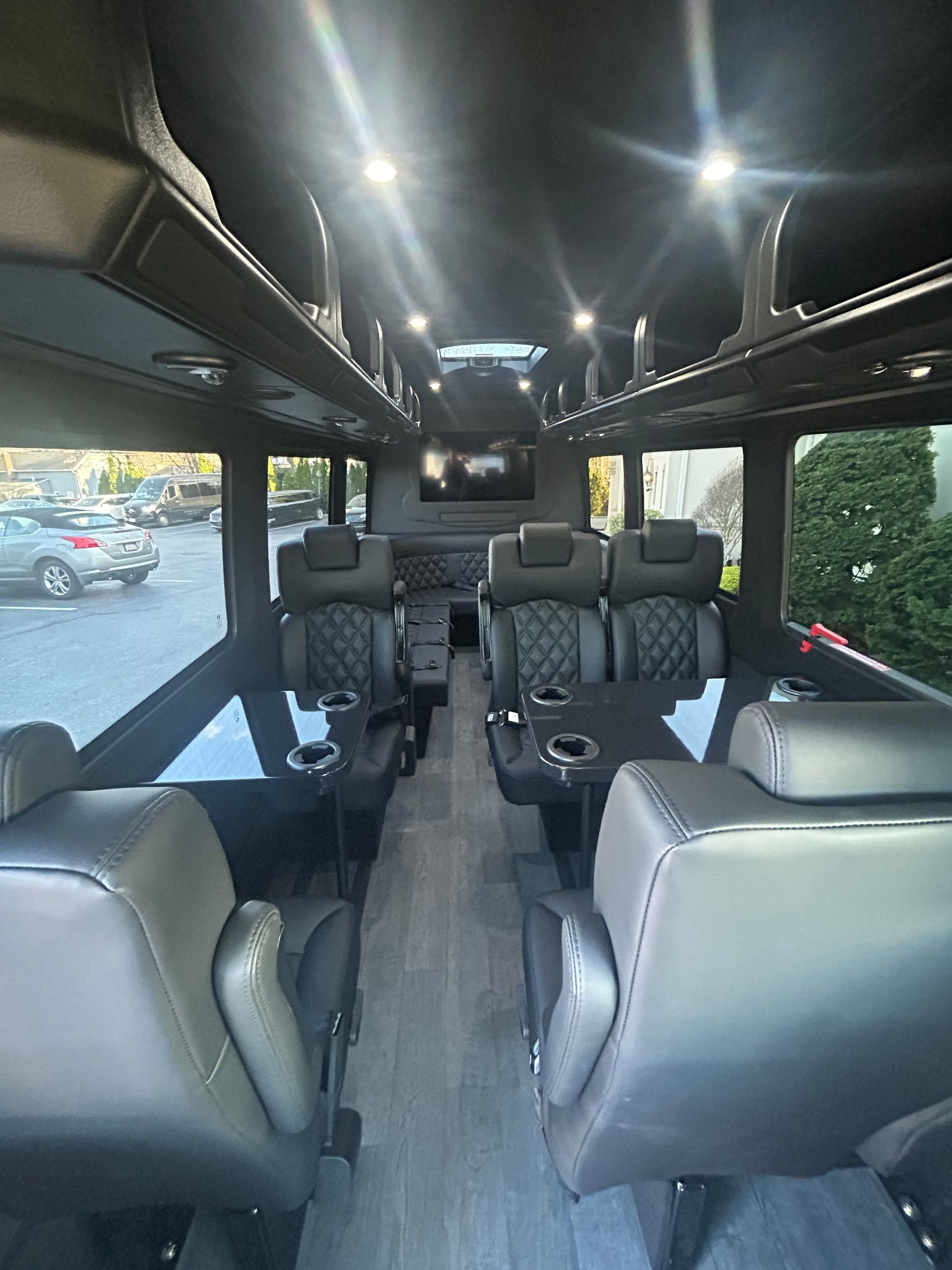 The inside of a van with lots of seats and a table.