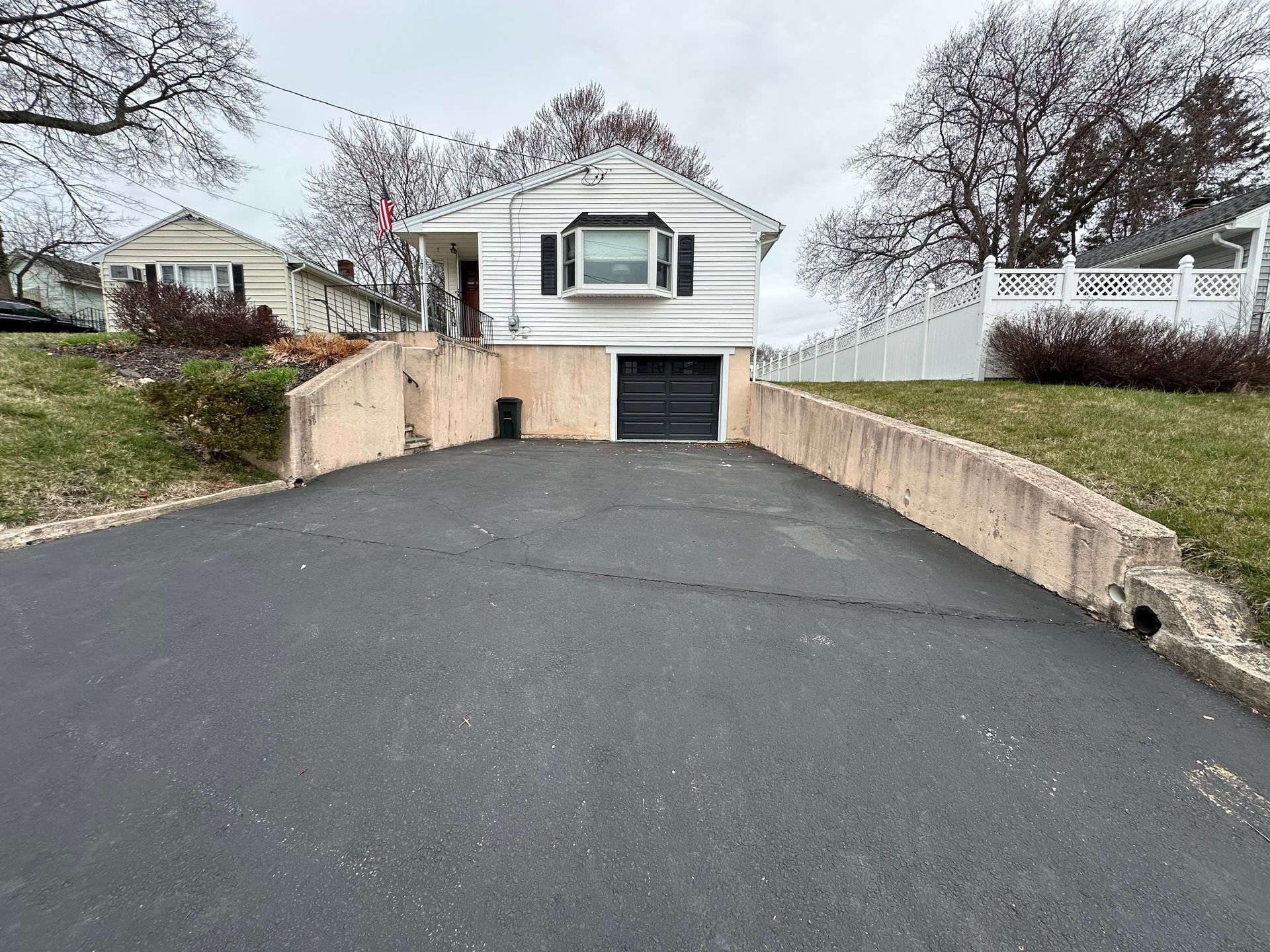 A driveway leading to a house with a garage.
