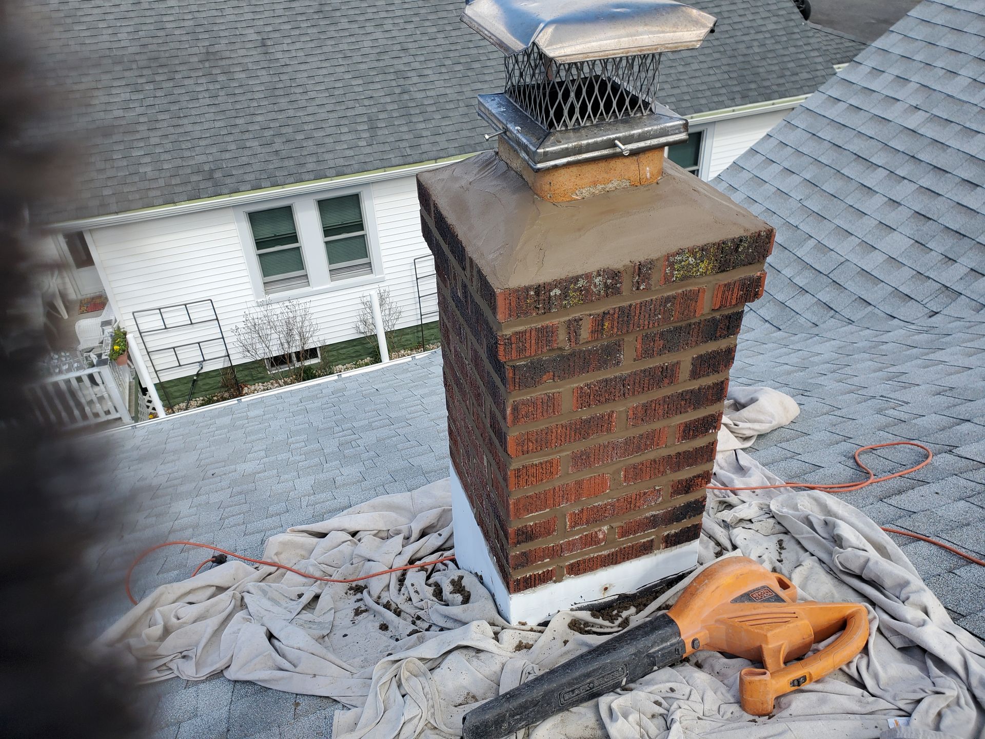 brick-chimney-overlooking-building-1920w.jpg