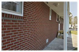 A wide shot of the outside of a red brick building