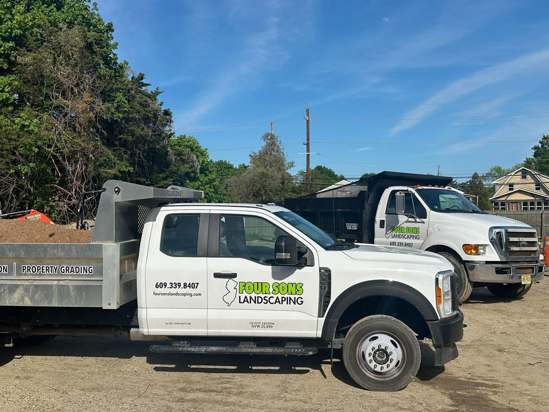 Two white dump trucks with 