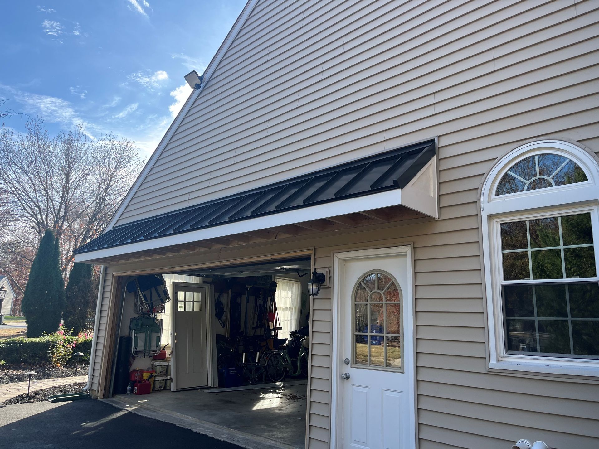 A house with a garage and a window on the side of it.