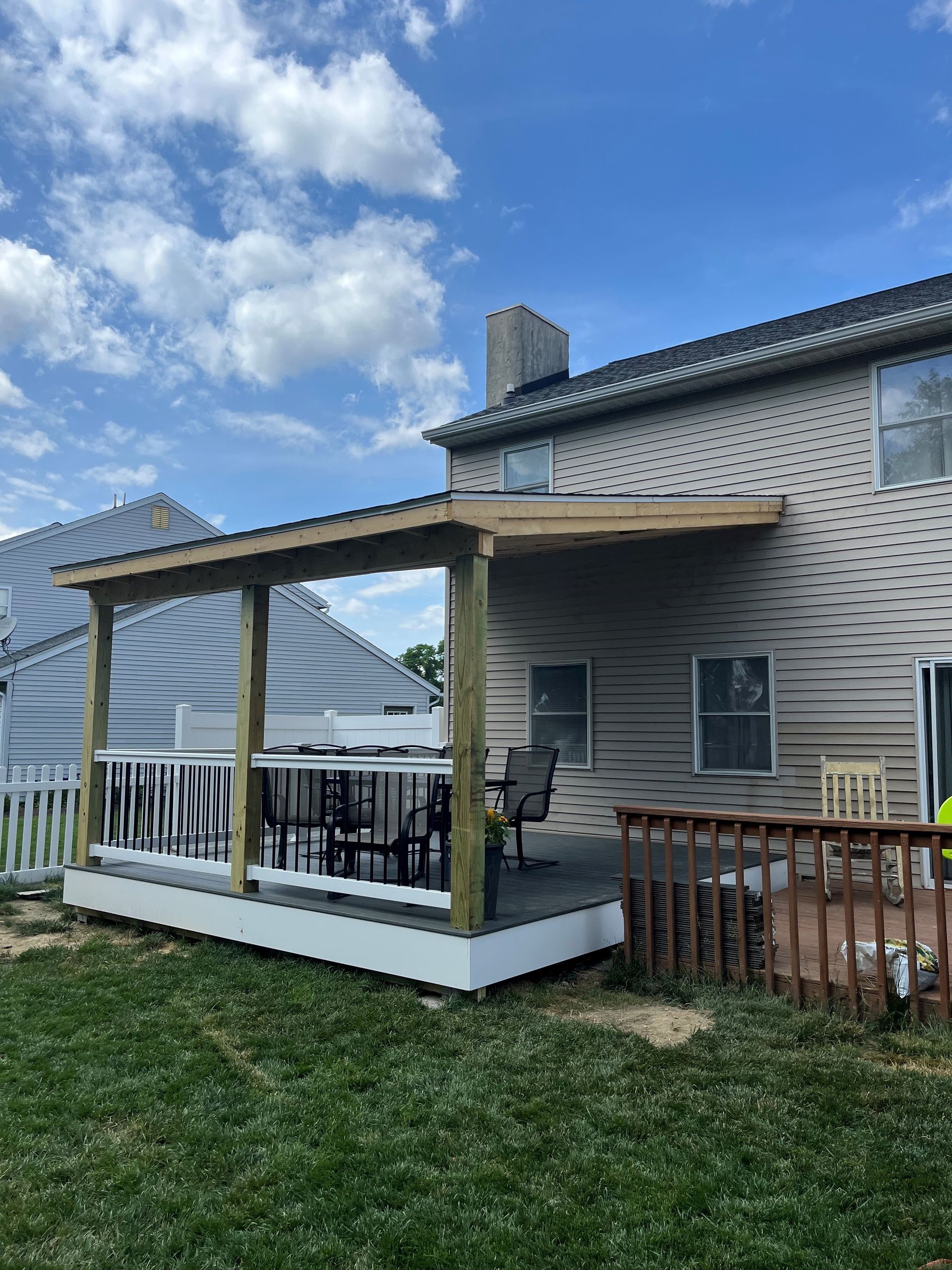A house with a covered deck in front of it