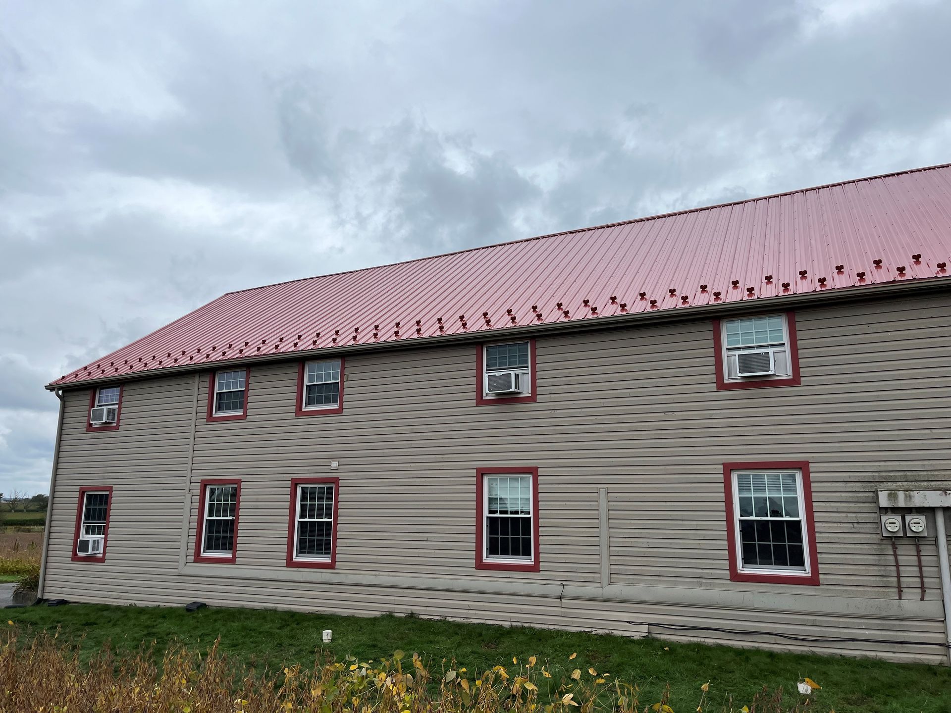 A large building with a red roof and a lot of windows.