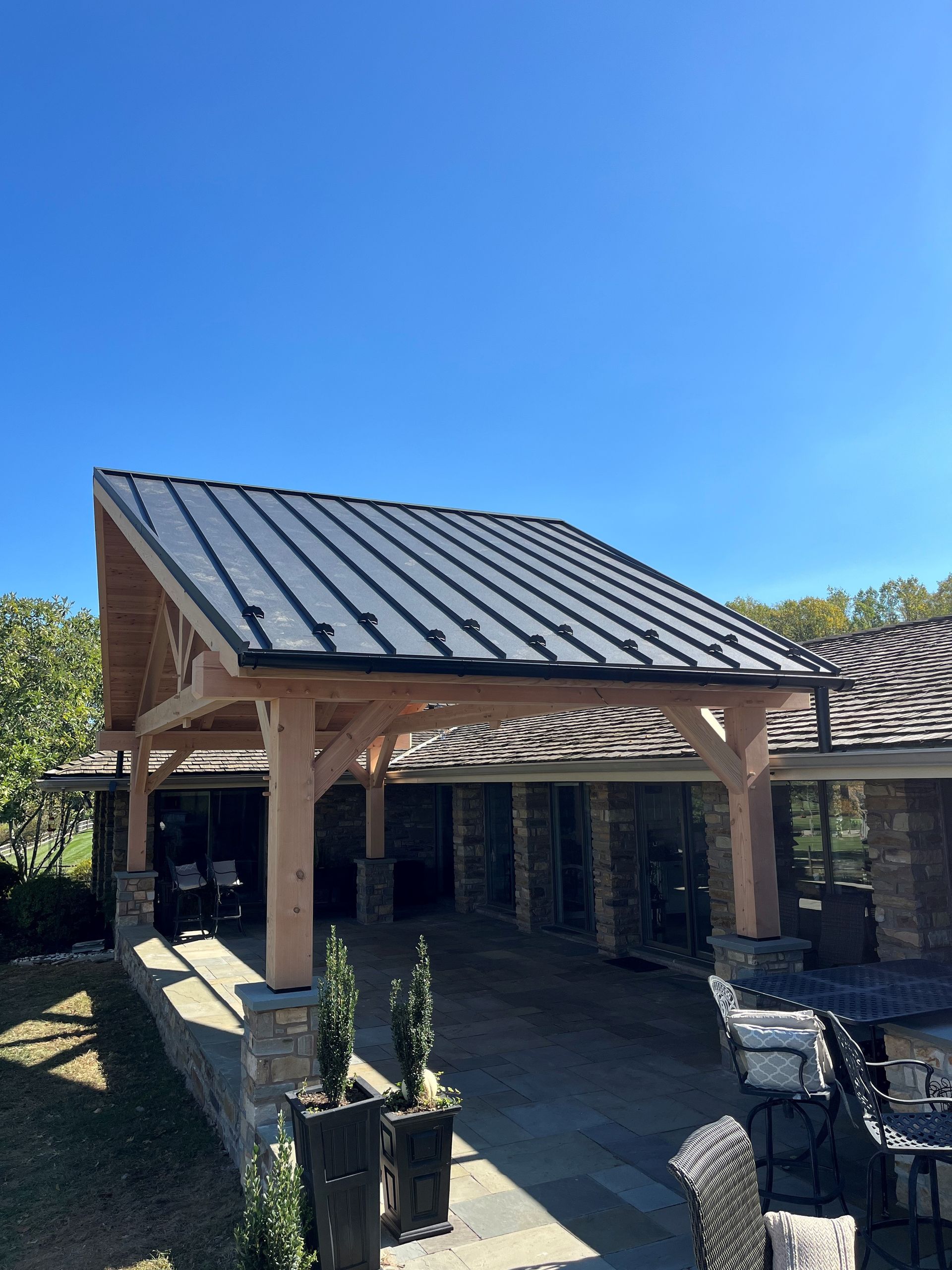 A house with a metal roof and a wooden frame