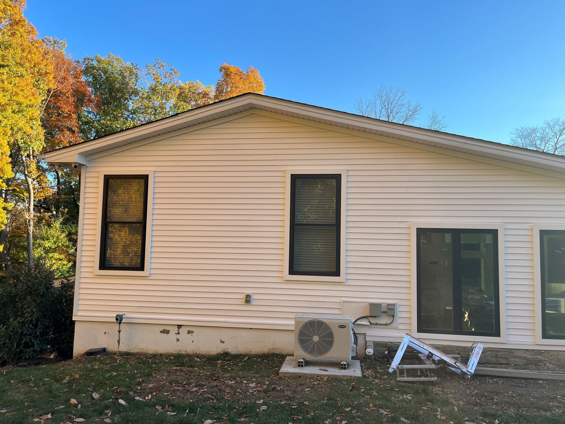 A white house with a large air conditioner on the side of it.