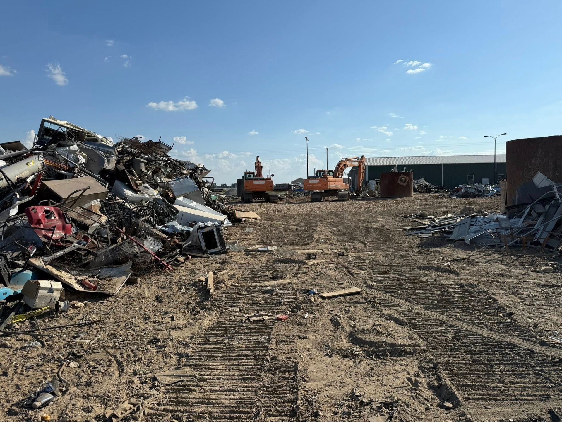 Pile of rusty and painted scrap metal at a recycling yard.
