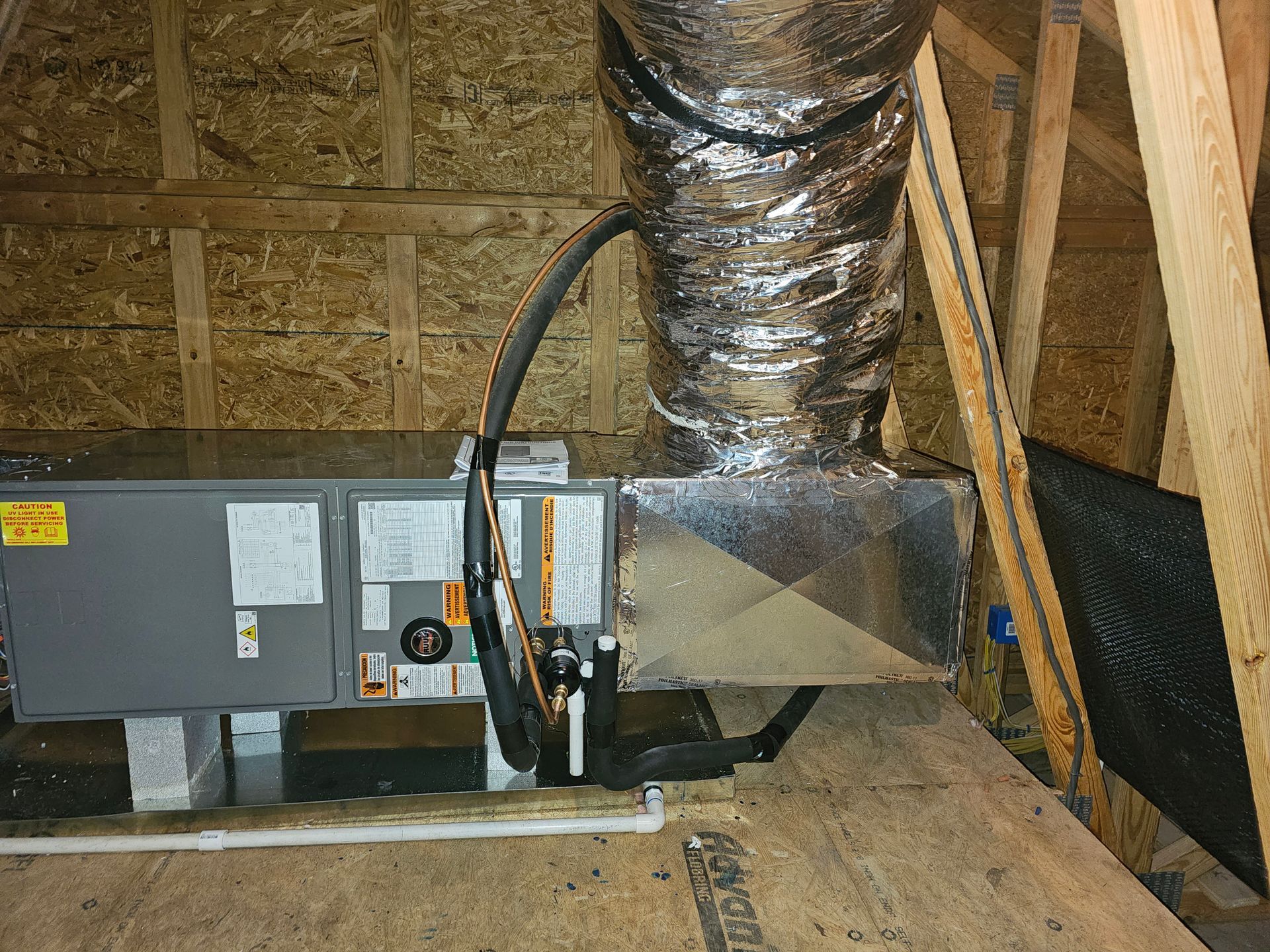 An air conditioner is installed in the attic of a house