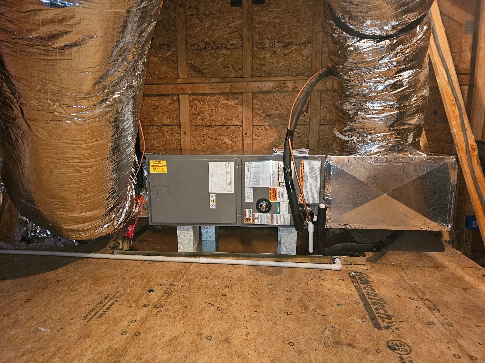 An air conditioner is installed in the attic of a house