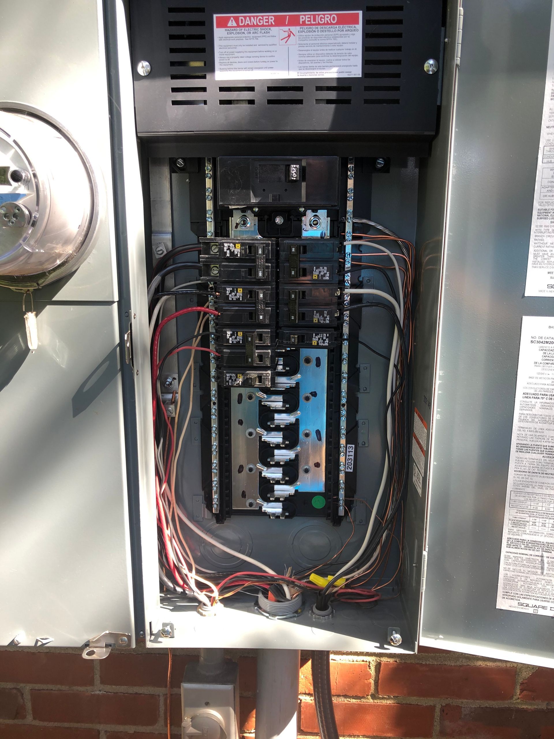 A close up of a electrical box on a brick wall