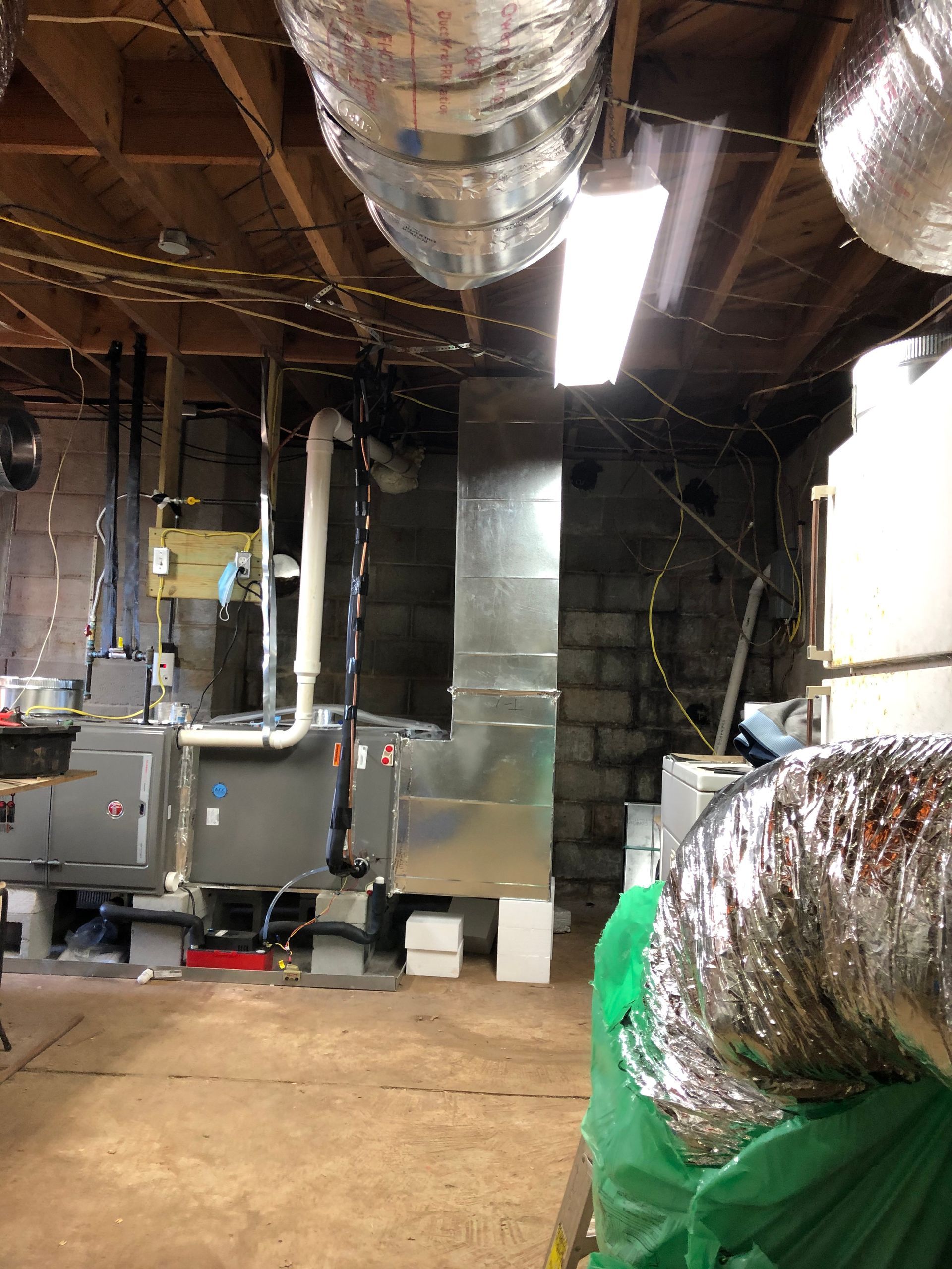 A room with a lot of ducts hanging from the ceiling