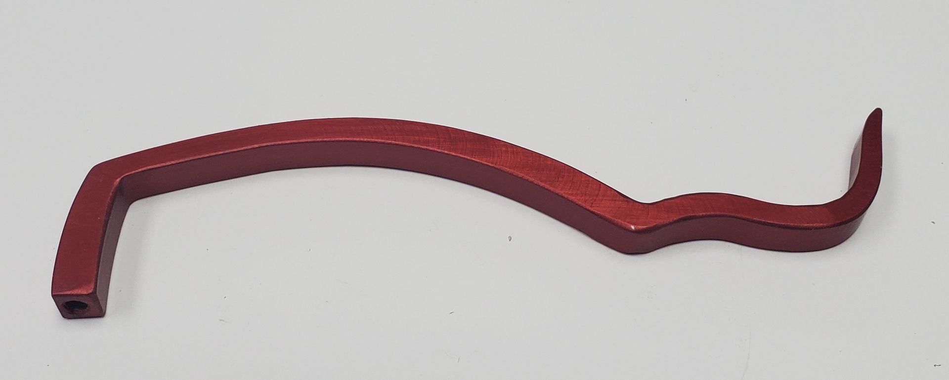 A curved, maroon-colored metal tool with a square-ended handle and a hooked tip, set against a light grey background.