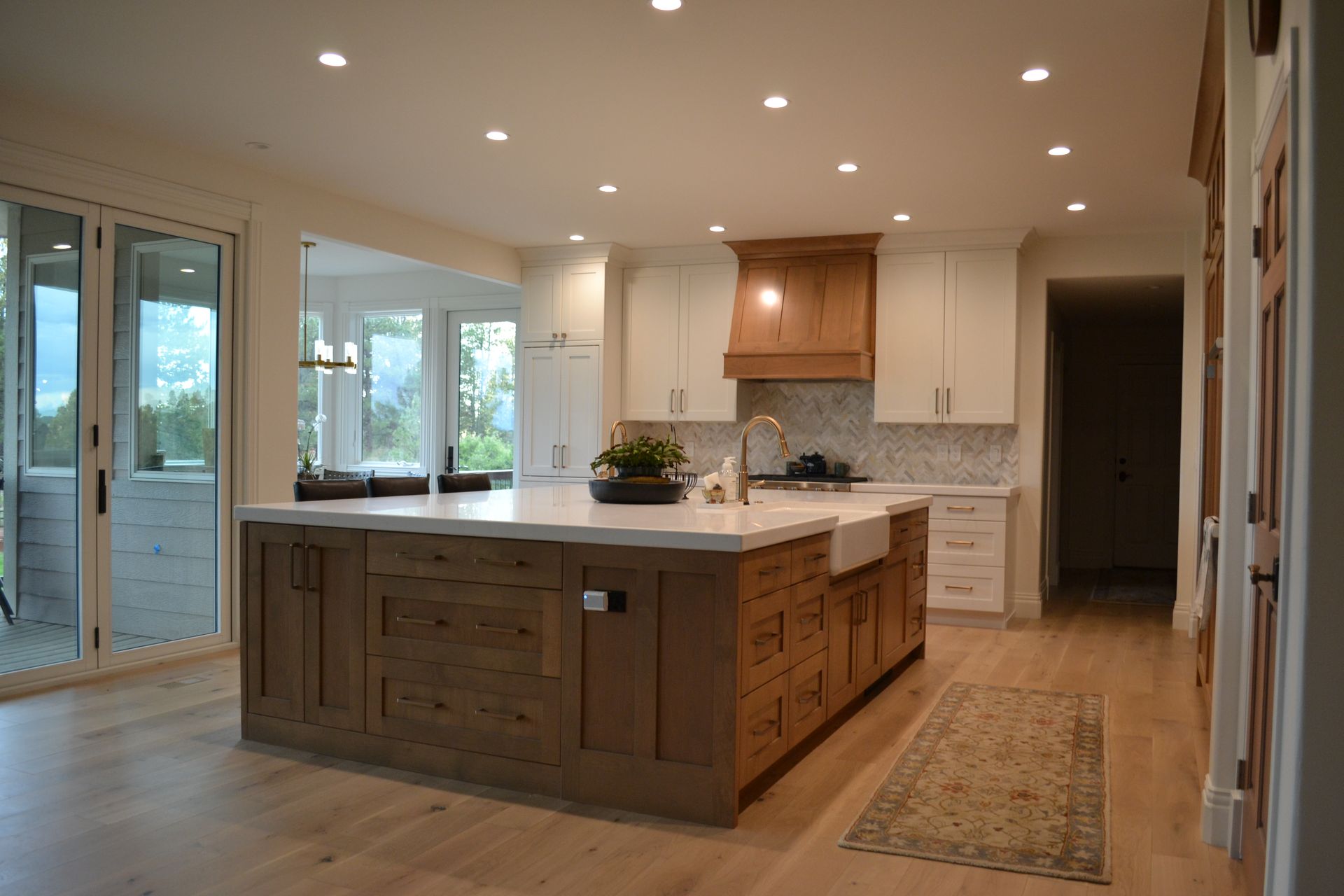 Spacious modern kitchen with island and light wood cabinets.