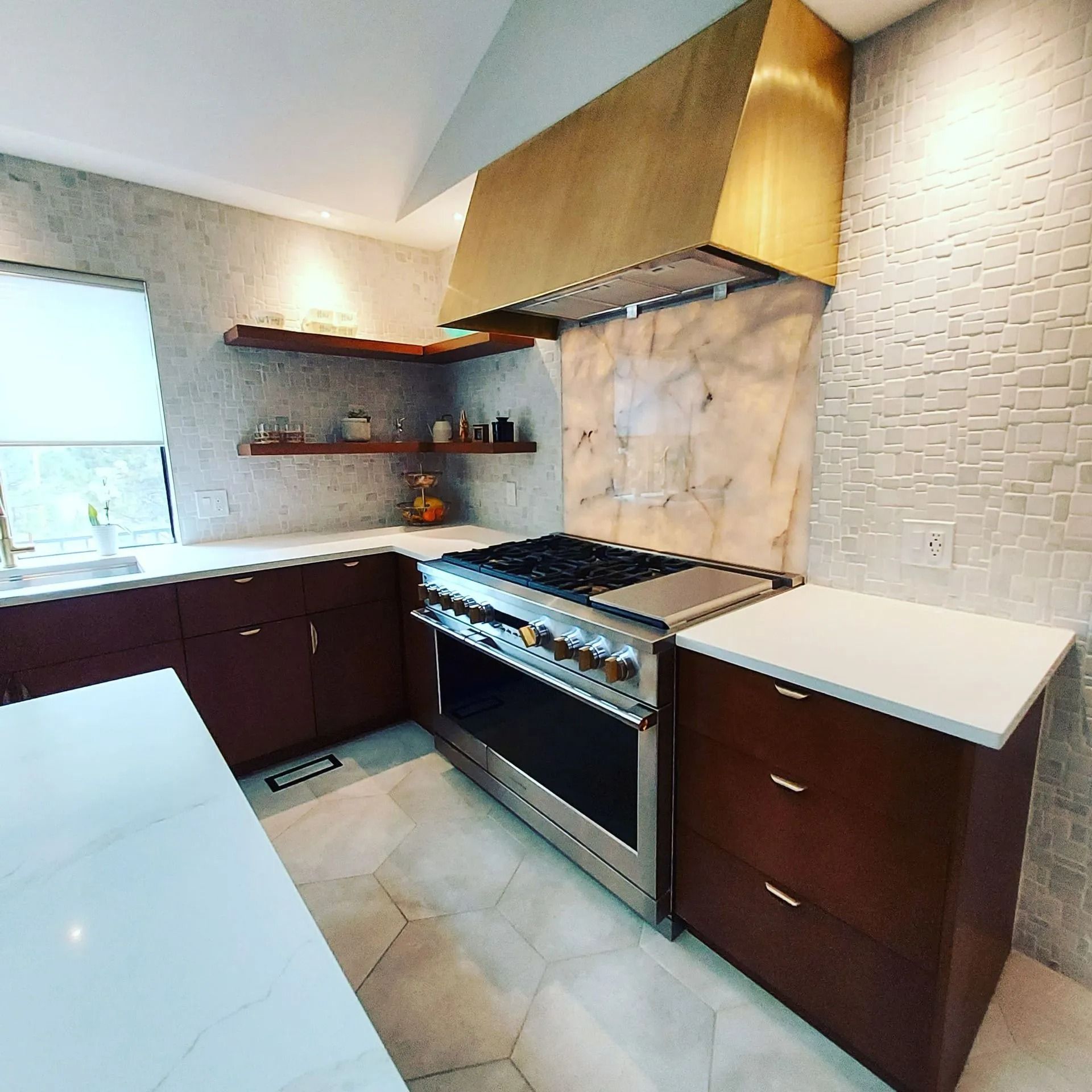 Kitchen with dark wood cabinets, a marble-top island, a bay window, and french doors.