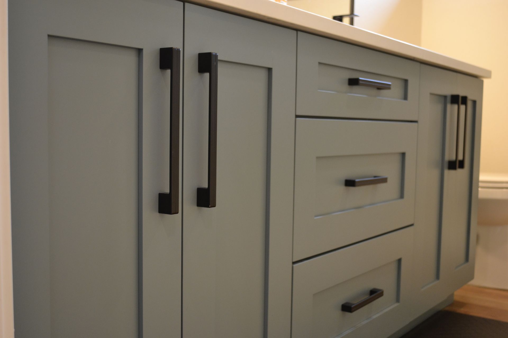 Light blue bathroom vanity with black hardware.